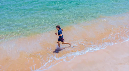 Man jogging on a Pacific Island beach.
